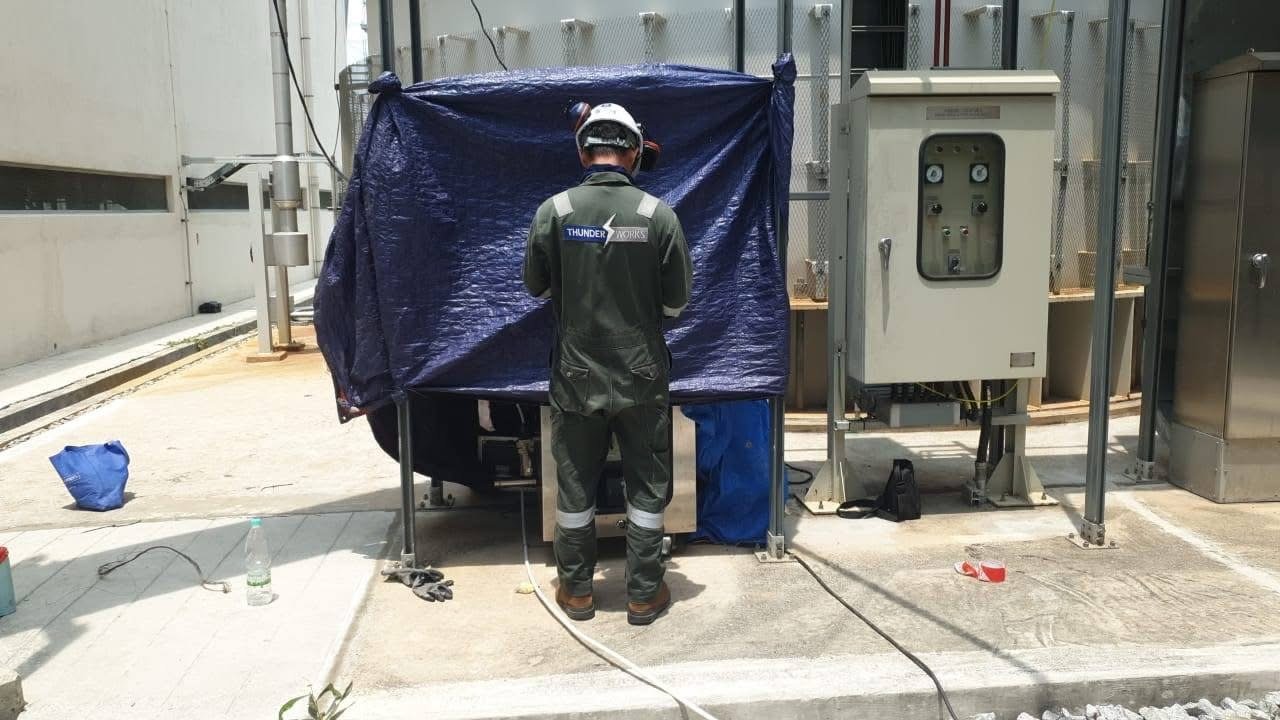 Thunderworks technician working on environmental monitoring equipment during an on-site installation